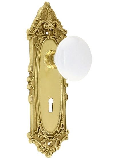 Largo Design Mortise Lock Set With White Porcelain Door Knobs in Unlacquered Brass.